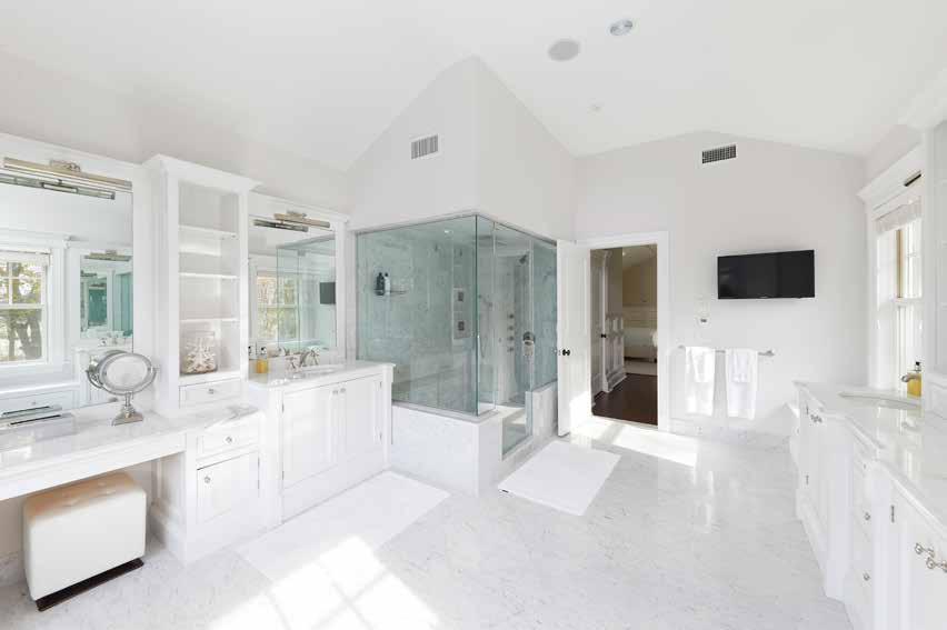 enclosed shower, and marble floors.