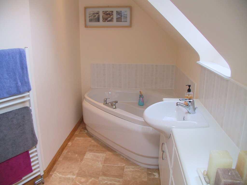 An ideal study which could also be utilised as a nursery if required. Velux window. Fitted carpet. FAMILY BATHROOM: Of striking appearance, this stylish bathroom features a white suite comprising a w.
