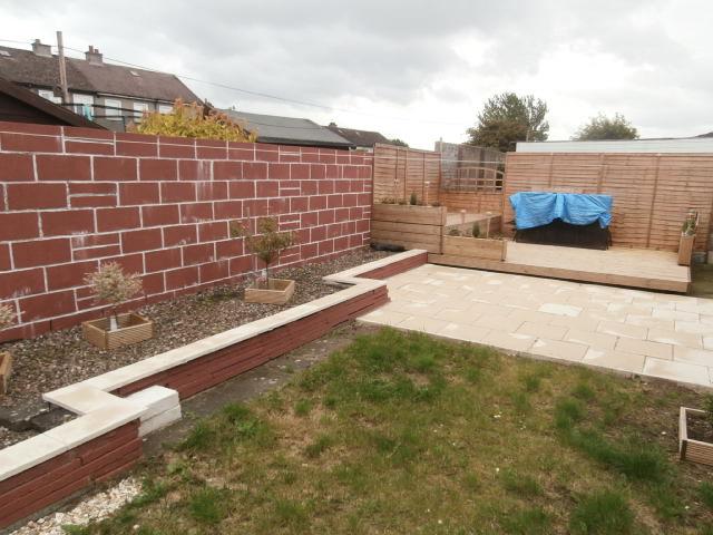 rear. The rear garden is split into 3 main areas, the first being a sheltered decking and seating