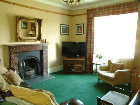 Cast iron fireplace with marble surround and hearth. Picture rail. Double window with views to the fells. Radiator. Carpet.
