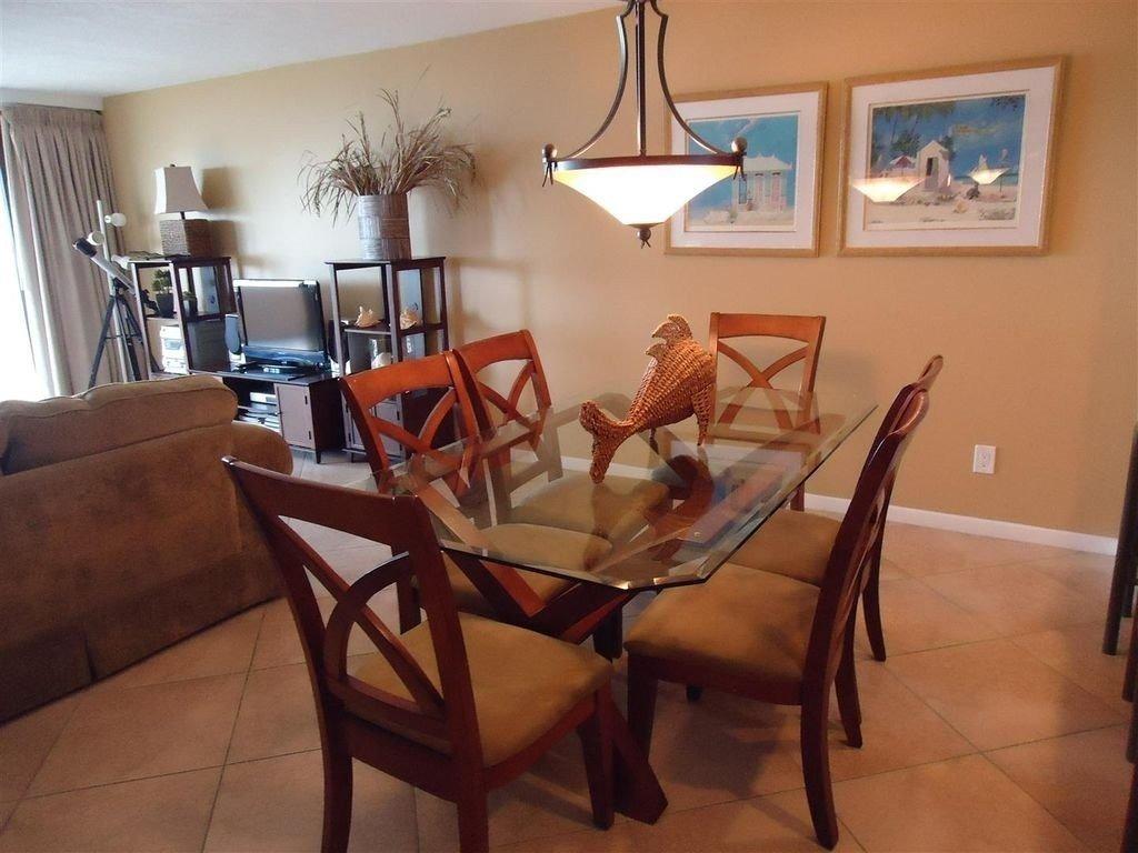 The living room furniture includes a sleeper sofa, love seat, coffee and end tables, lamps, and entertainment center. The dining room features a beautiful table, 6 chairs, and 3 bar stools.