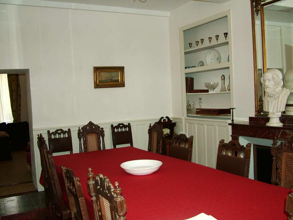 Opposite the kitchen is the dining room, dominated by a 4 leaf dining table. This room is panelled to waist height has an impressive marble fireplace and marble fronted reveals to the double windows.