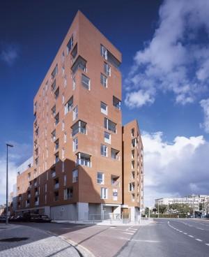 housing scheme by FKL Their strategy was to design two restrained, L-shaped red brick blocks and sit them down on a grey stone and mosaic tile plinth This distinct