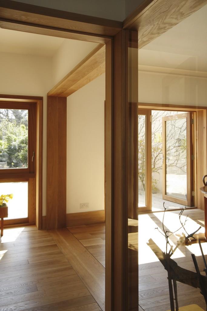 interior of oak and cedar is matched with a timber exterior of cedar, left to go grey Old steel windows are replaced with new windows, made by the same manufacturer of