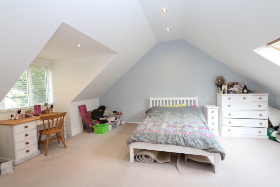 Bedroom 4 11 7 x 8 4 Solid wood flooring, sloping ceilings, undereaves storage and dormer window to