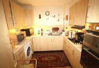 58 (7'10" x 8'6") Having a good range of base and wall fitted kitchen units, work surfaces over, tiled splash backs, integrated washing machine, integrated