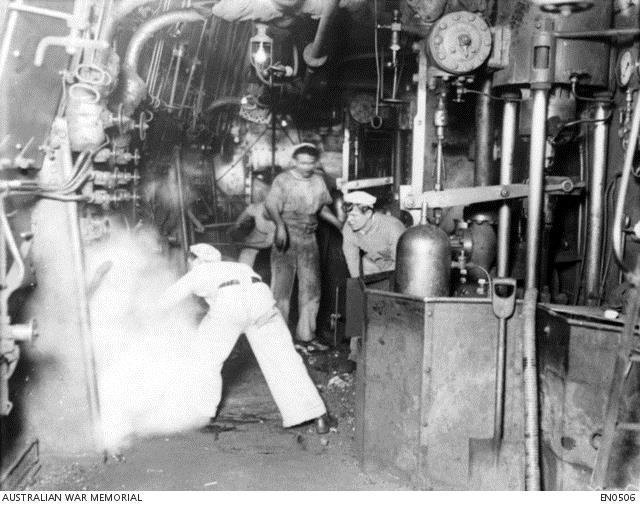 Unidentified stokers at work in the boiler room on