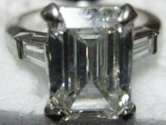 VALUATION 1 DIAMOND RING Set with an emerald-cut diamond, weighing approximately 4.