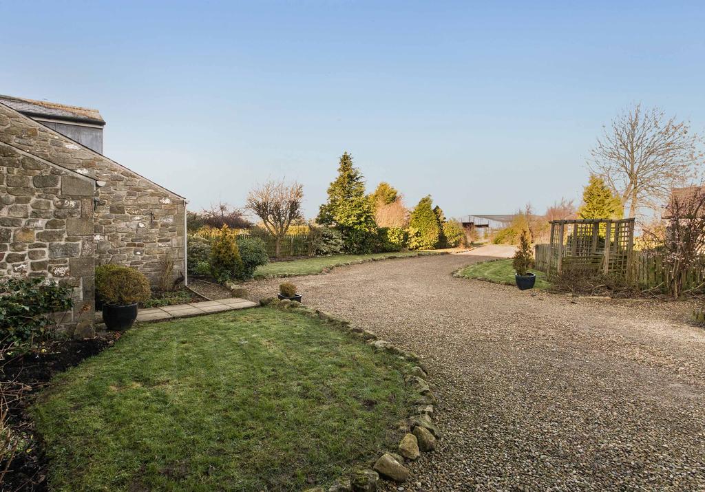 EXTERNALLY A separate outbuilding, once the milking parlour, has been converted into an office/ studio with french doors looking out onto the enclosed rear garden and towards the main house.