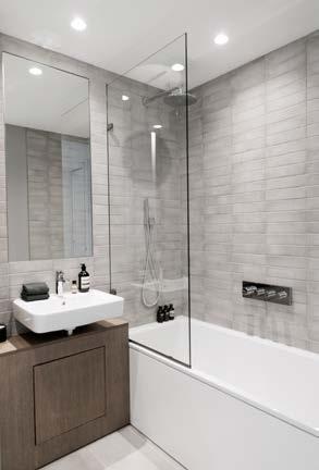 The en-suite bathroom combines modern design with spacious luxury.