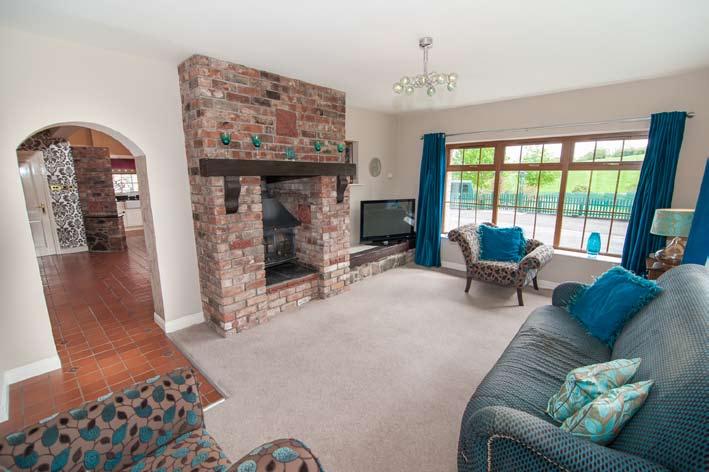 FAMILY ROOM: 17' 2" x 13' 0" (5.23m x 3.96m) Red brick chimney breast with wooden mantel and wood burning stove. Ceramic tiled floor. Views over front, side and rear. Door connecting to.