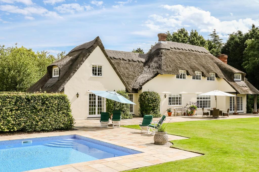 The Thatched House is a striking four bedroom detached family residence benefitting from four reception rooms, four bathrooms, set well back from Mill Green Road within a beautiful, established and
