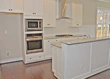 stained raised panel wood cabinets in Kitchen with cushion close &