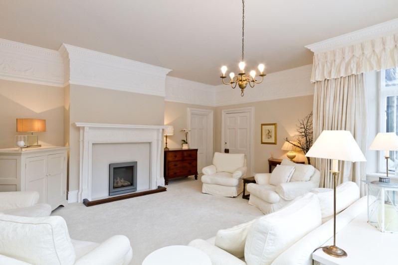 75m) One of the principle rooms of the original residence, this large living room and dining space has some fine oak panelling to the picture rail, ornate plaster detailing to the ceiling,