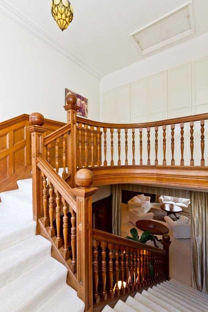 First Floor From the dining hall, the lovely easy, wide oak dogleg staircase leads past leaded windows on the half landing, curving onto the generous first floor landing where there