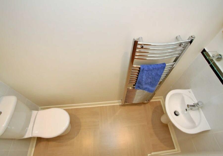 CLOAKROOM 2.1m x 0.8m (6'11" x 2'7") Comprising a WC and basin, this cloakroom is handy and extremely functional. The walls are partially tiled and there is an extractor fan and glass display shelf.