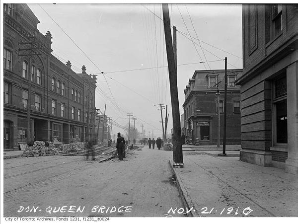 and second floor of the Edwin Hotel, 650 Queen Street East, with the rusticated base and a stone pier with a