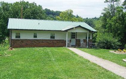 Has a large screened in porch on back, landscaped, has 2 outbuildings, and is in a private location. Yet close to town. Affordable country living at its best!