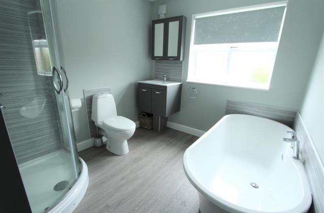 BATHROOM 2.30m (7' 7") x 2.55m (8' 4") Fitted with a modern four piece suite comprising a double ended bath with central mixer tap, close coupled w.