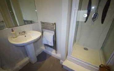 hand basin, low flush WC. Separate shower cubicle with jet massage system. Tiled floor.