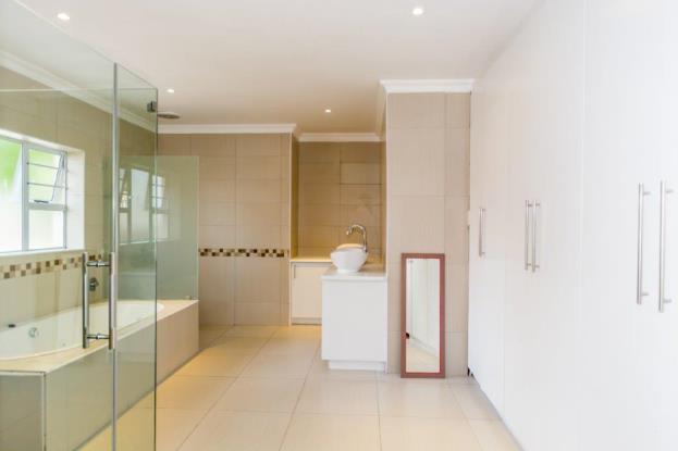 open plan en-suite bathroom, featuring a built-in bath,