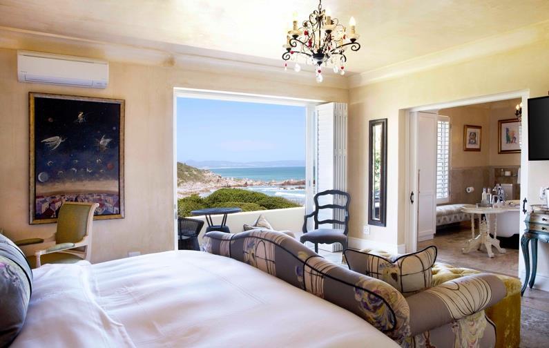 view. Luxuriate in the plush King-size bed with gold-framed headboard.