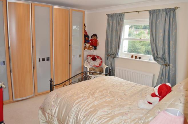 BEDROOM THREE 3.95m (13' 0") x 3.3m (10' 10") A double bedroom with double glazed window to front and a double panelled radiator.