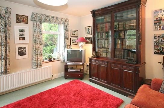 Cast iron fireplace with tiled hearth, picture rail, fitted book shelves and Chinese slate floor. Open plan through arch to:- Kitchen: 13 2 x 8 4.