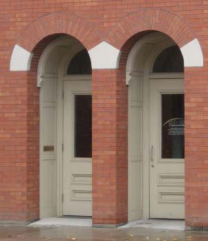 *Limestone and brick, segmented labels on Fifth Street, street-level windows and doorways *decorative brick