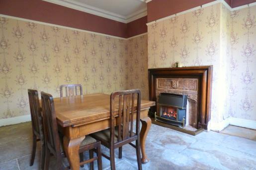 Again, this room presents an original tiled fireplace with wooden mantelpiece that currently has a modern style gas fireplace.