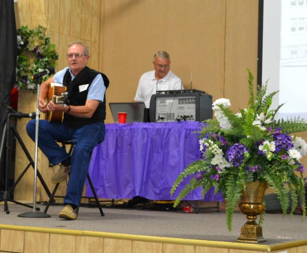 Larry Miller (on left ) from the class of 1963 provided some of the entertainment at the banquet by singing and playing his Martin guitar.