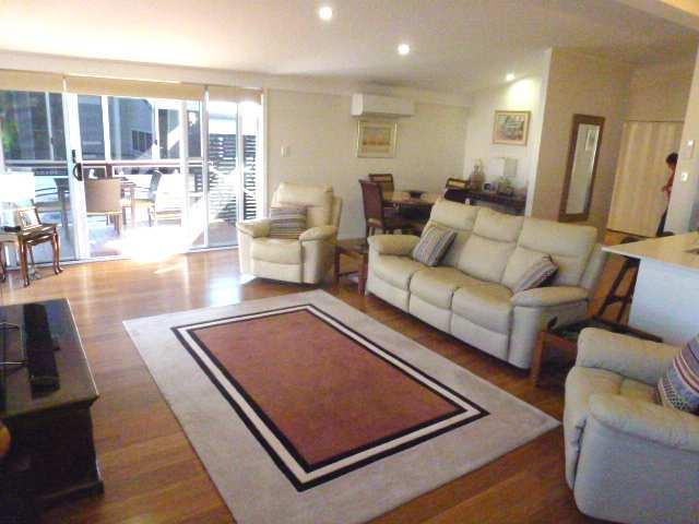 Spacious living area. Timber flooring and carpet.