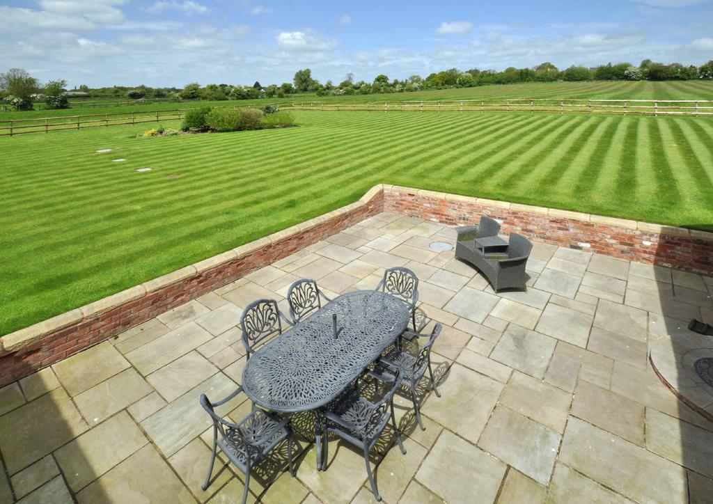There is a second drive laid in brick setts to the side of the cottage with remote controlled gates and the gardens lead around the side of the house to the rear lawns with paved patio and terracing.