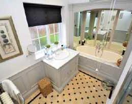 FAMILY BATHROOM A fabulous Heritage bathroom suite comprising vanity unit incorporating wash hand basin.