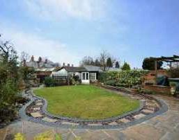 Gated access to the rear garden. REAR GARDEN Well landscaped with a recently laid patio area. Partly laid to lawn.