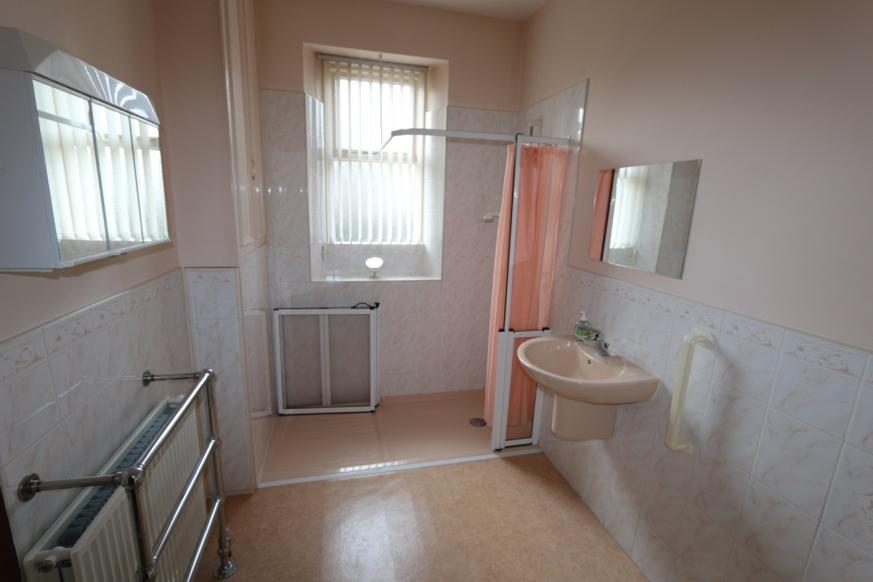 Bedroom/Rear Room measuring 3.27m x 3.15m or thereby with window to rear. Radiator. Fitted kitchen unit and small cupboard. Sink with drainer and taps. Kitchen measuring 2.57m x 3.
