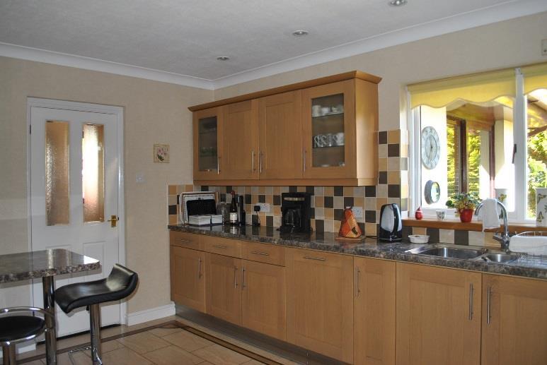 - 6 - BREAKFAST KITCHEN (15 5 x 11 2 approx.) A lovely fully fitted kitchen with light oak wall and base units with cupboards and drawers. Glass fronted display cabinets and breakfast bar.