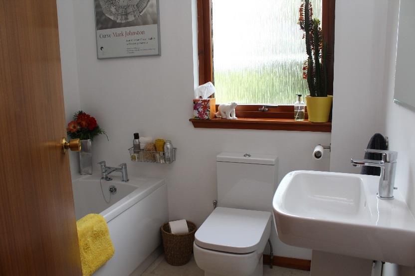 BATHROOM: Freshly presented the centrally situated family bathroom has been fitted with a modern three piece white suite with a vanity mirror and