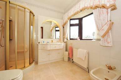 INNER HALLWAY: Walk in shelved hot press. BATHROOM: 11 6 x 11 2 (3.51m x 3.4m) Coloured suite. Jacuzzi bath with mixer taps. Separate shower enclosure. Wash hand basin in vanity unit. Low flush WC.