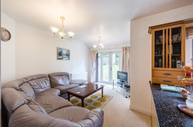 spacious driveway which is partly block paved, there are two up and over doors leading to the double garage, double glazed door leading to the entrance hall and a path leading to the side of the