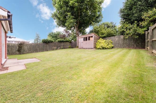 GARDEN With access via double glazed patio doors leading from the lounge and kitchen sitting room this private rear garden has a small patio area with lawn beyond with a mature tree, various small