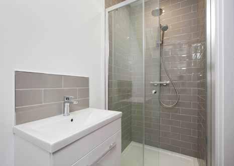 ENSUITE: Fully tiled shower enclosure with watering can shower and