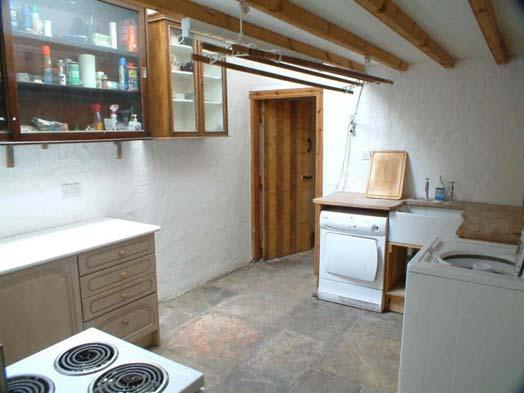 whole of the ground floor. Range of wall and base units. Dishwasher. Heated flagged floor. Beams in ceiling.