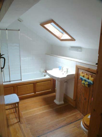 Pitch pine wood floor. Storage under eaves. Cupboard with water tank. Family Bathroom 2.06m x 2.