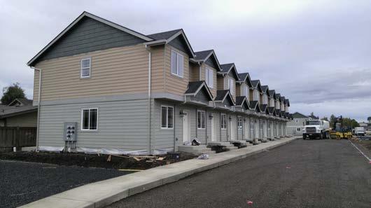 structure, consisting of two to eight (usually) attached single-family homes placed side by side.