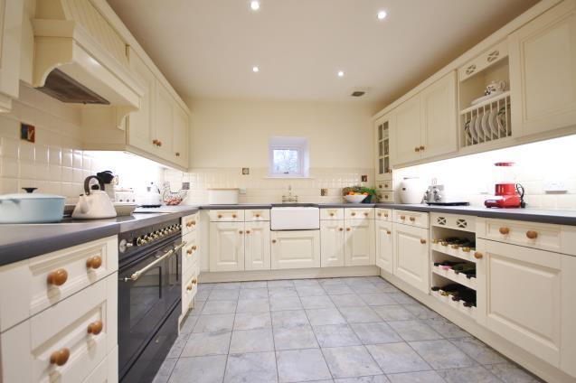 The impressive four bedroom conversion has generous accommodation set over two floors, with a superb 29ft sitting room, two private courtyard gardens, a driveway and allocated parking.