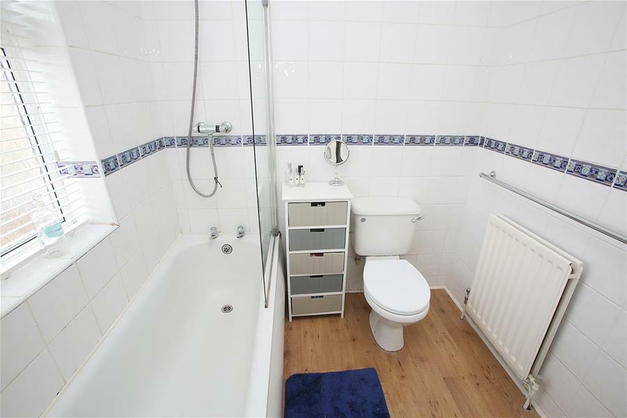 08) Fitted with a white suite comprising of a panelled bath with shower