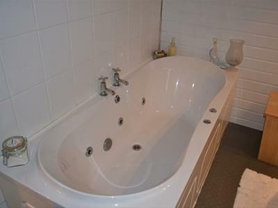 House Bathroom Three piece suite, spa panel bath with chrome taps, low level WC, wash basin