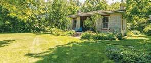 The property includes a spacious brick patio under stately maples and the grounds come alive in the spring creating the perfect setting