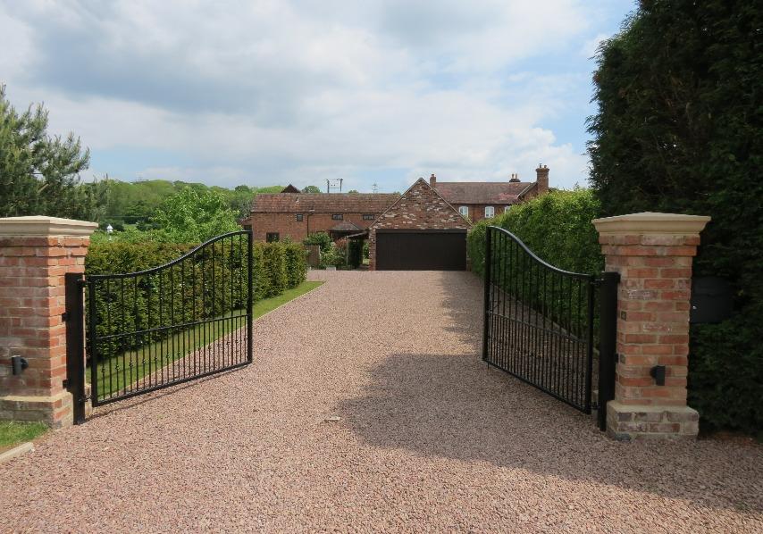 The property is raised and sits near to the back of the plot looking down over its carefully landscaped gardens.